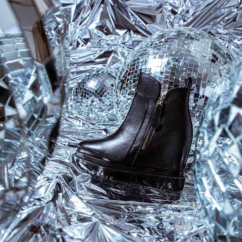 Black Leather Ankle Boots Featuring Stylish Wedge Heel Design