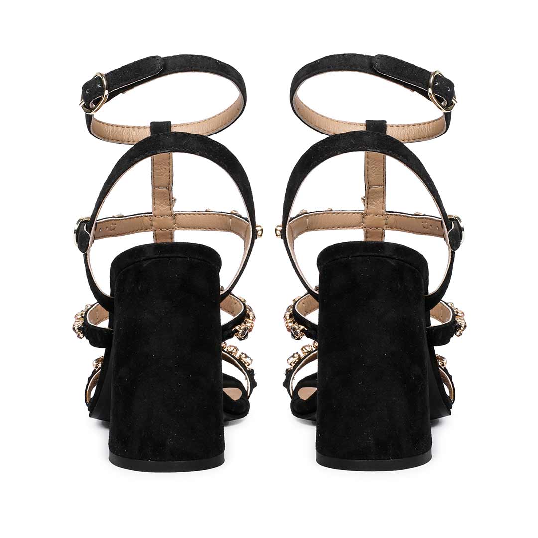 Striking black heels with intricate stone detailing by Saint Gretel.