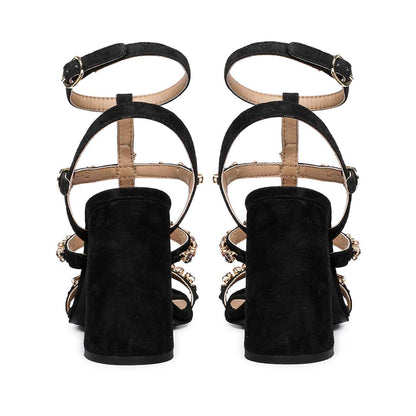 Striking black heels with intricate stone detailing by Saint Gretel.